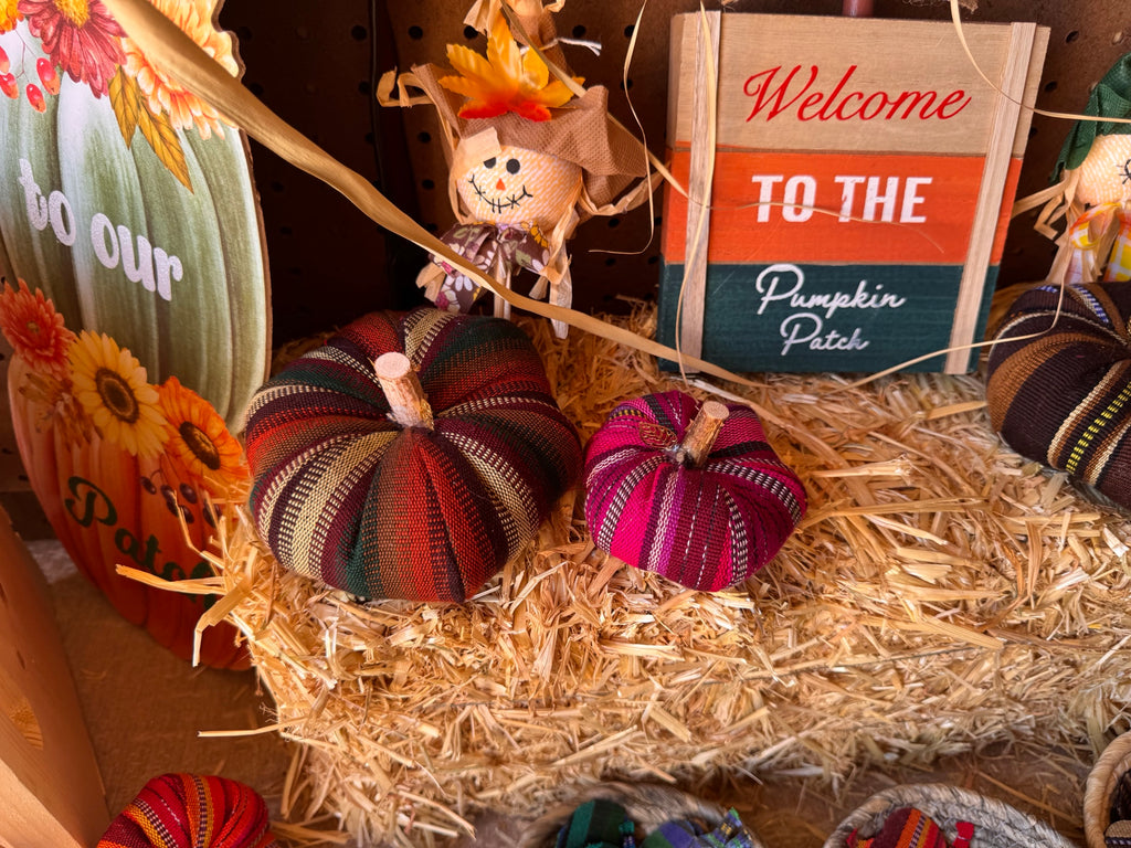 Decorative textile pumpkins in a fall display
