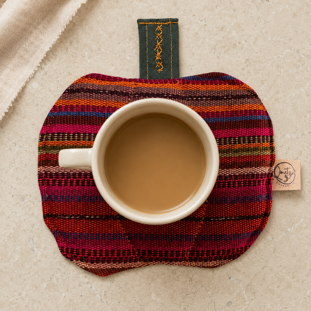 Pumpkin Heat-Resistant Mug Rug in use with a mug
